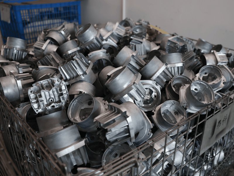 Die-cast aluminium LED work light housings fresh from casting in a steel stillage