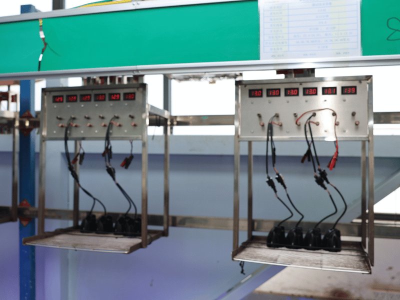LED work lights on a burn-in rack running a two-hour test alternating between 12V and 24V input