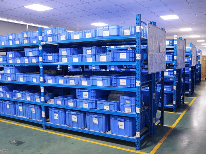Organised materials warehouse with labelled component bins on racking
