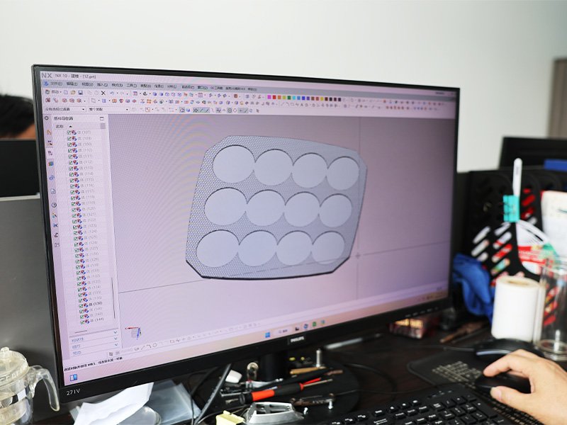 An engineer designing the optical lens array of an LED work light in 3D CAD
